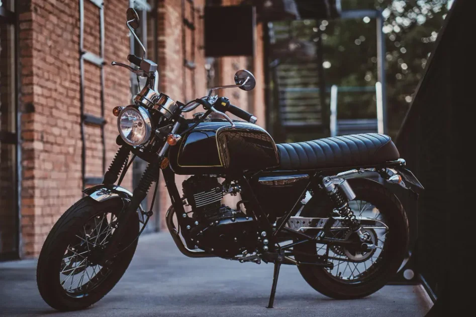 Klassisk motorcykel parkeret ved murstensbygning